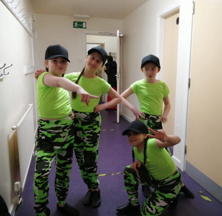 Contemporary dance sequence under spotlights